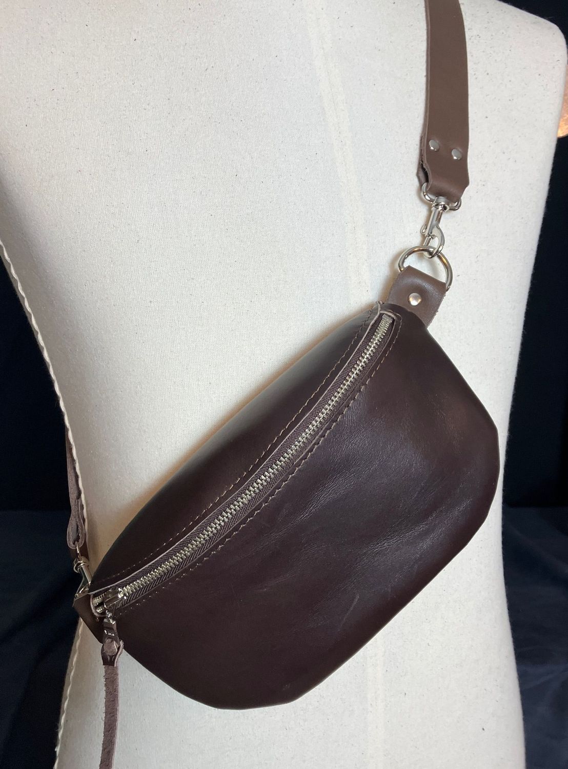 A brown body pouch displayed on mannequin