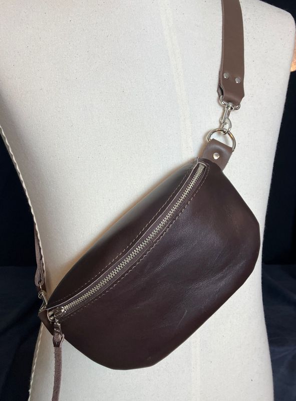 A brown body pouch displayed on mannequin
