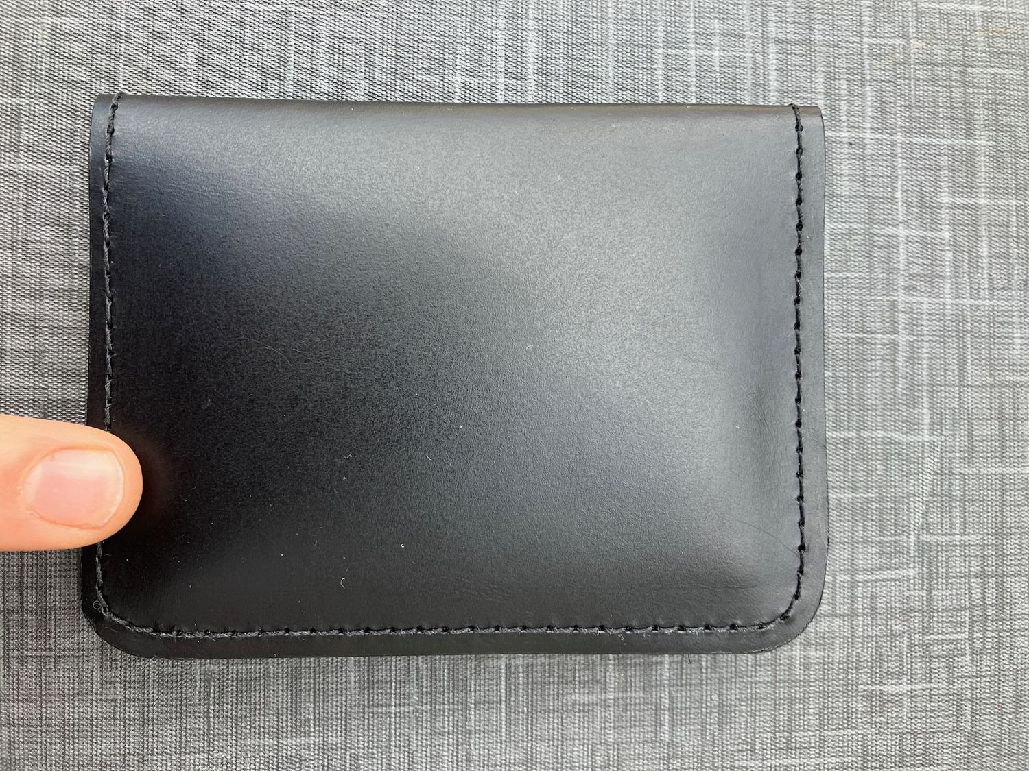 An image of the front of a Medium Two-Fold wallet in black