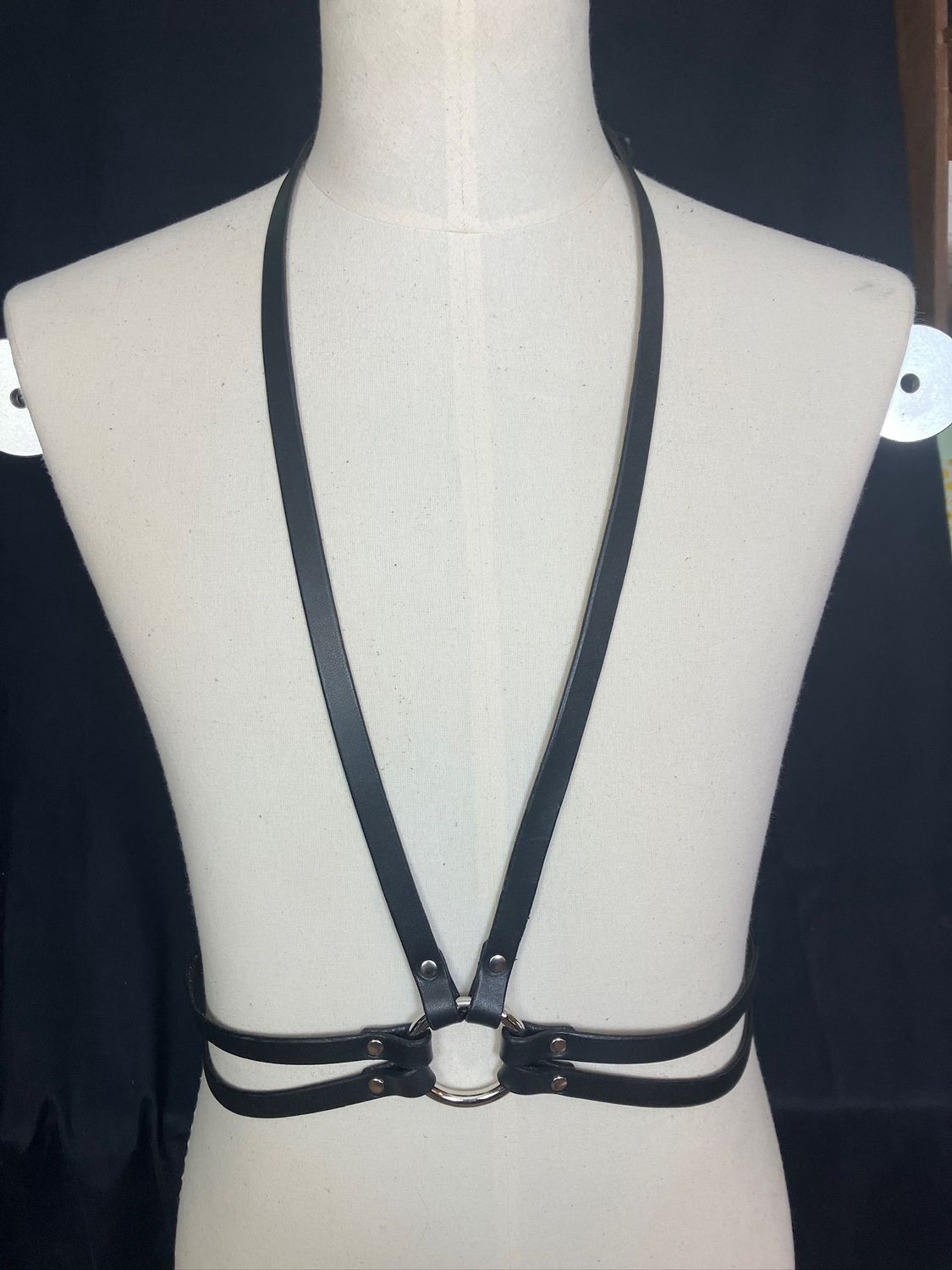 The Downright Harness in black displayed on a mannequin. Long low V front, with double strap waist belt.