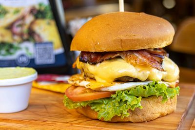 "Cheese Burger with Beef Patty at Pizza Corner UAE - Juicy Beef Patty Topped with Melted Cheese, Fresh Lettuce, Tomato, and Cucumber in a Soft Bun"