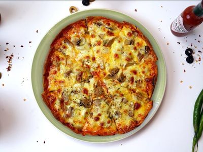 A delectable Pizza Al Fanghi topped with melted mozzarella cheese, earthy mushrooms, and a sprinkle of fresh herbs on a golden, crispy crust. The mushrooms add a rich, savory flavor, and the cheese is perfectly bubbly around the edges. Served hot on a wooden board, ready to savor each bite.