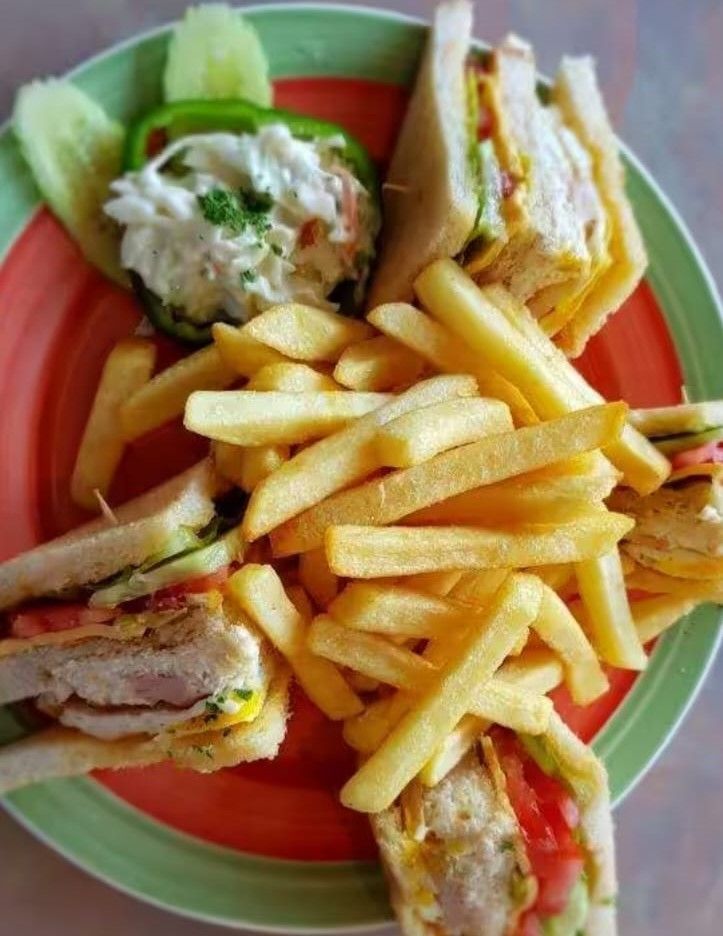 "Club Sandwich at Pizza Corner UAE - Layered with Fresh Ingredients, Served with Crispy French Fries"