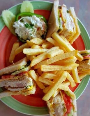 "Club Sandwich at Pizza Corner UAE - Layered with Fresh Ingredients, Served with Crispy French Fries"