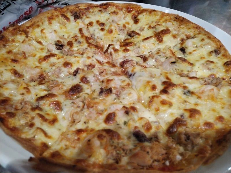 "Pizza Fritti di Mare at Pizza Corner UAE - Topped with Fresh Seafood, Including Shrimp, Calamari, and Mussels for a Flavorful Ocean-Inspired Pizza"