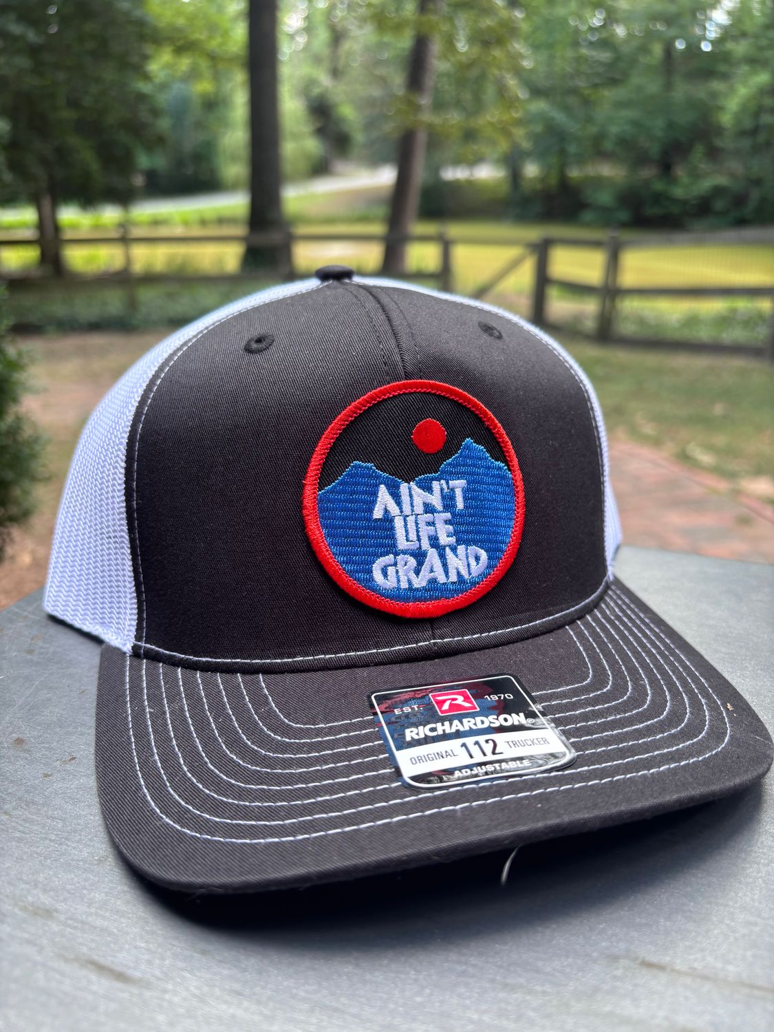 Ain't Life Grand Black/White Trucker Hat