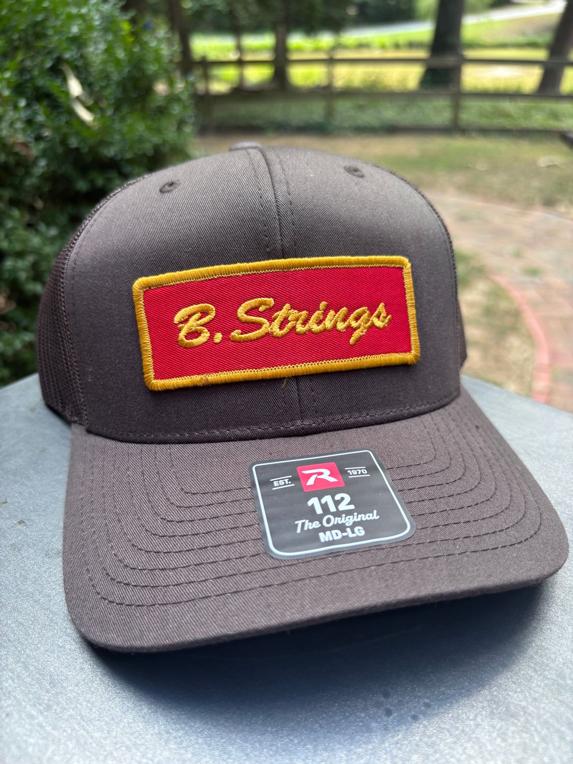 B. Strings Brown Trucker Hat