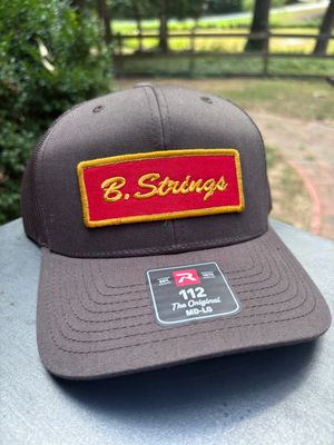 B. Strings Brown Trucker Hat