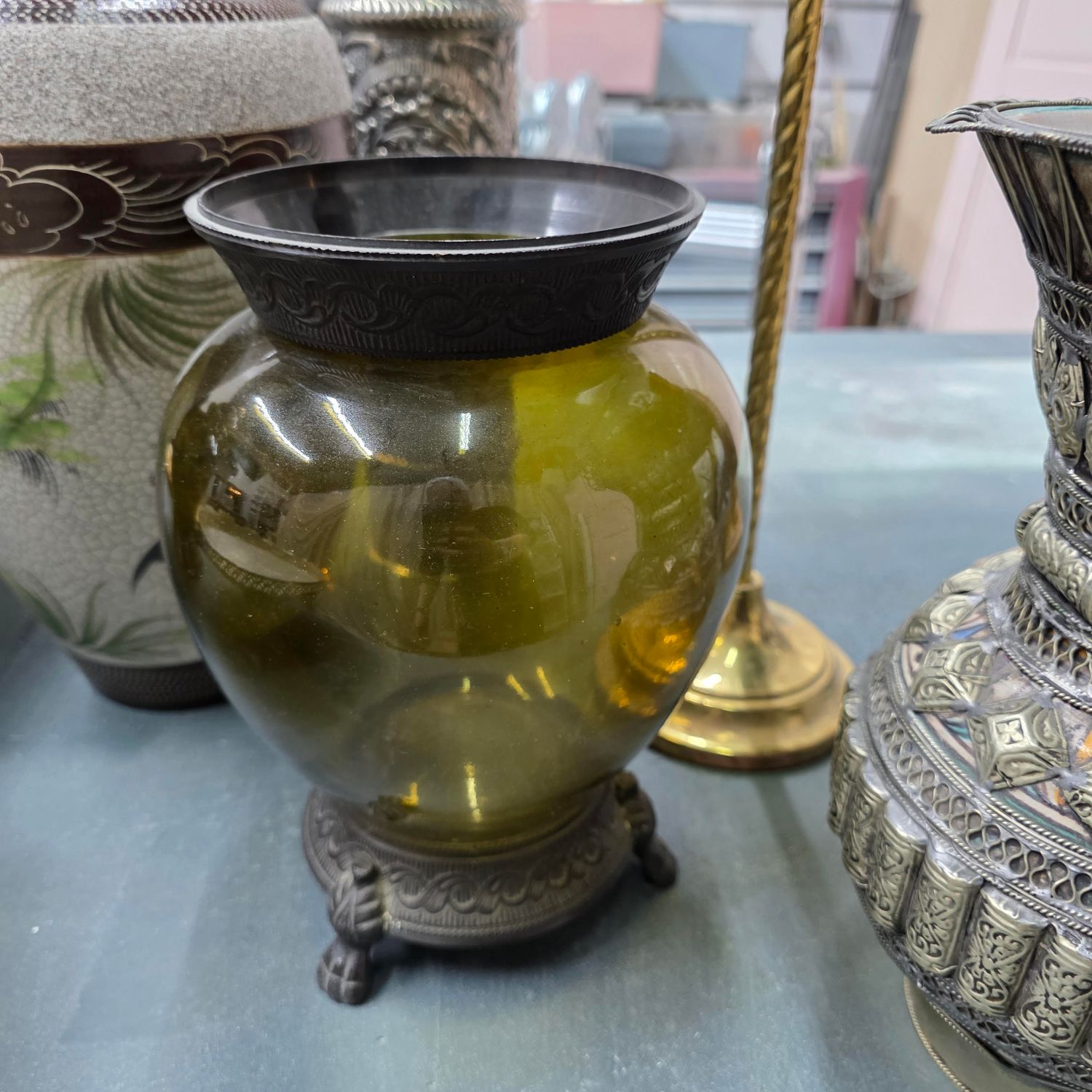 ANTIQUE GLASS VASE WITH A BRASS STAND.