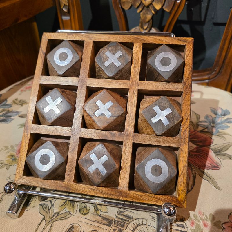 HANDCRAFTED WOODEN TIC TAC TOE SET SERVING AS BOTH A FUNCTIONAL TABLETOP GAME AND A DECORATIVE ITEM