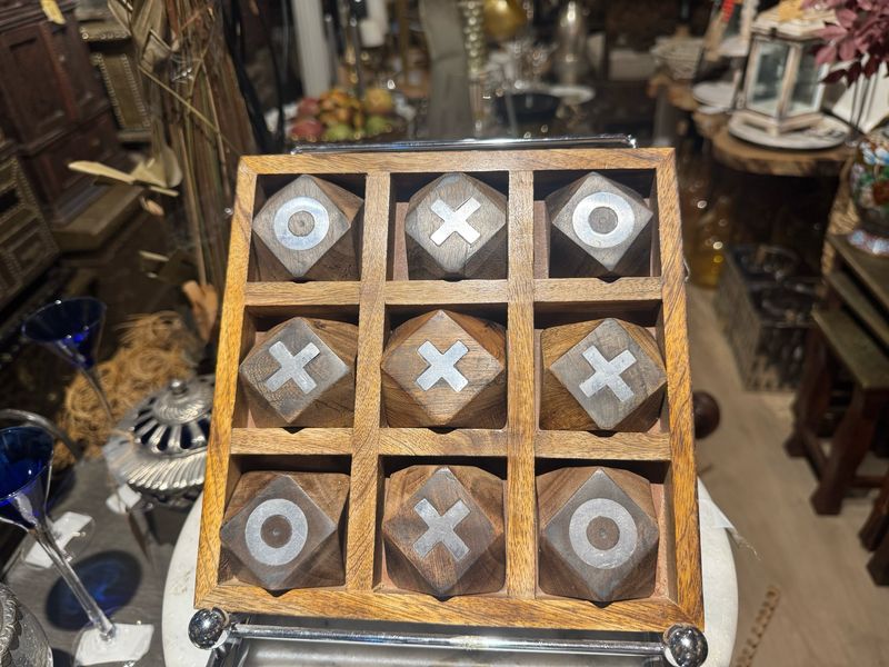 HANDCRAFTED WOODEN TIC TAC TOE SET SERVING AS BOTH A FUNCTIONAL TABLETOP GAME AND A DECORATIVE ITEM