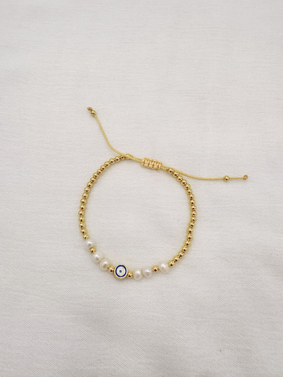 Pulsera de Ojo Turco con Perlas y bolitas doradas en acero bañado en oro de 18K PU2061G47 Pulsera de Ojo Turco con Perlas y bolitas doradas en acero bañado en oro de 18K PU2061G47