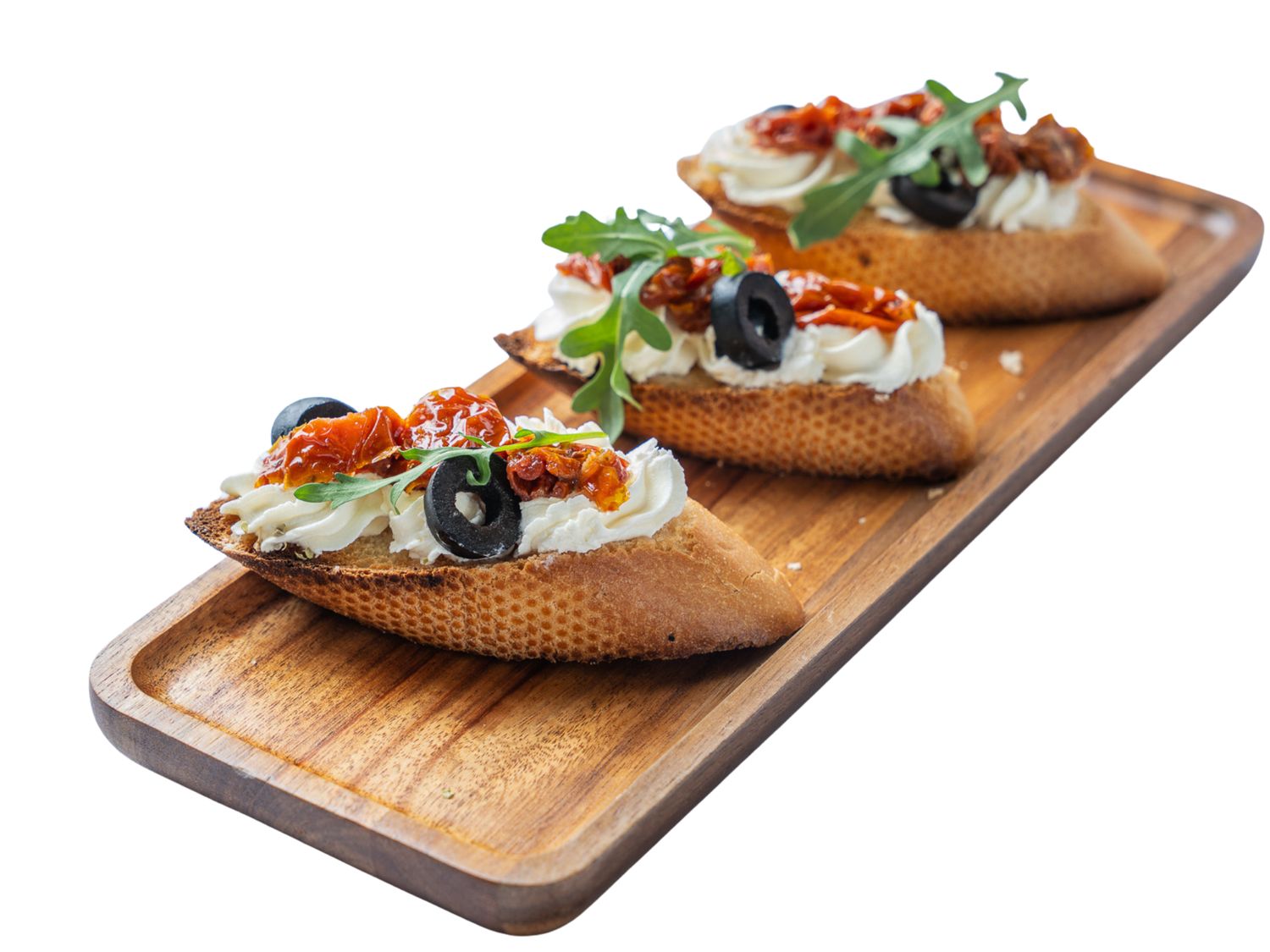 Bruschetta z serkiem wytrawnym, suszonymi pomidorami i rukolą