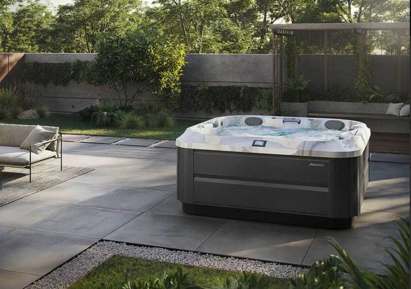 Jacuzzi® J-332 Spa blanc et noir sur térrace en dalle grise de chez home spa jacuzzi