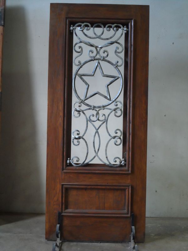 Custom Oak Wood Door with Ornate Iron Grille