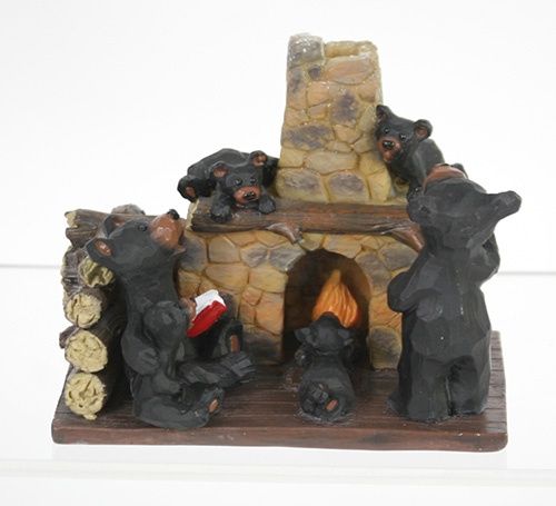 Bear family reading by fire
