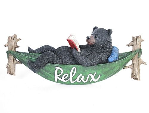 BEAR READING BOOK IN HAMMOCK