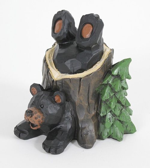 Playful bear in a stump
