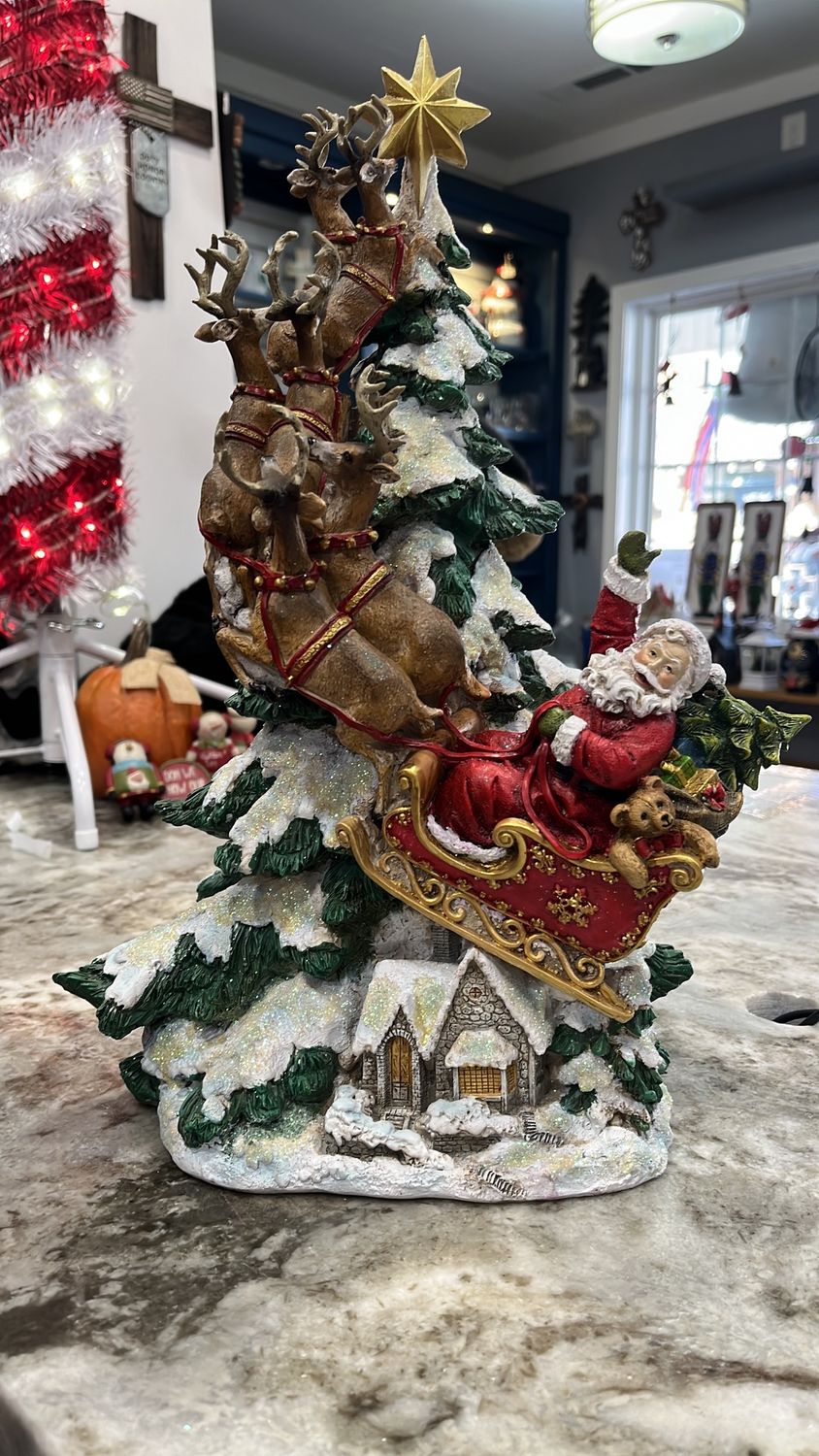 Santa &amp; deer riding sleigh to sky