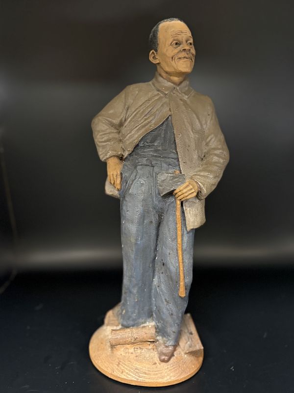 Sculpted Figure. USA. Tom Clark. Ezra. Signed. Man of Color Wearing Blue Overalls &amp; Brown Coat &amp; Holding an Ax. 1993. 12&#39;&#39;H