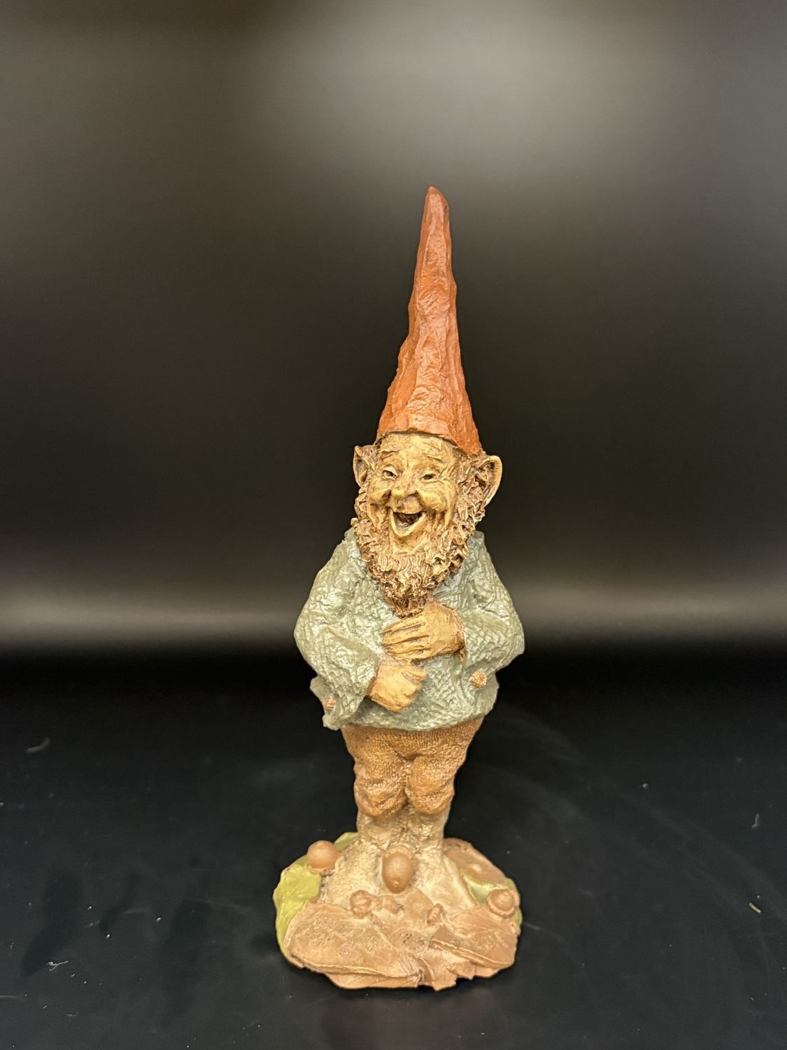 Sculpted Figure. USA. Tom Clark. Troutman. Gnome standing and smiling in blue shirt with hands on stomach. 1985. 7.5&#39;&#39;H.