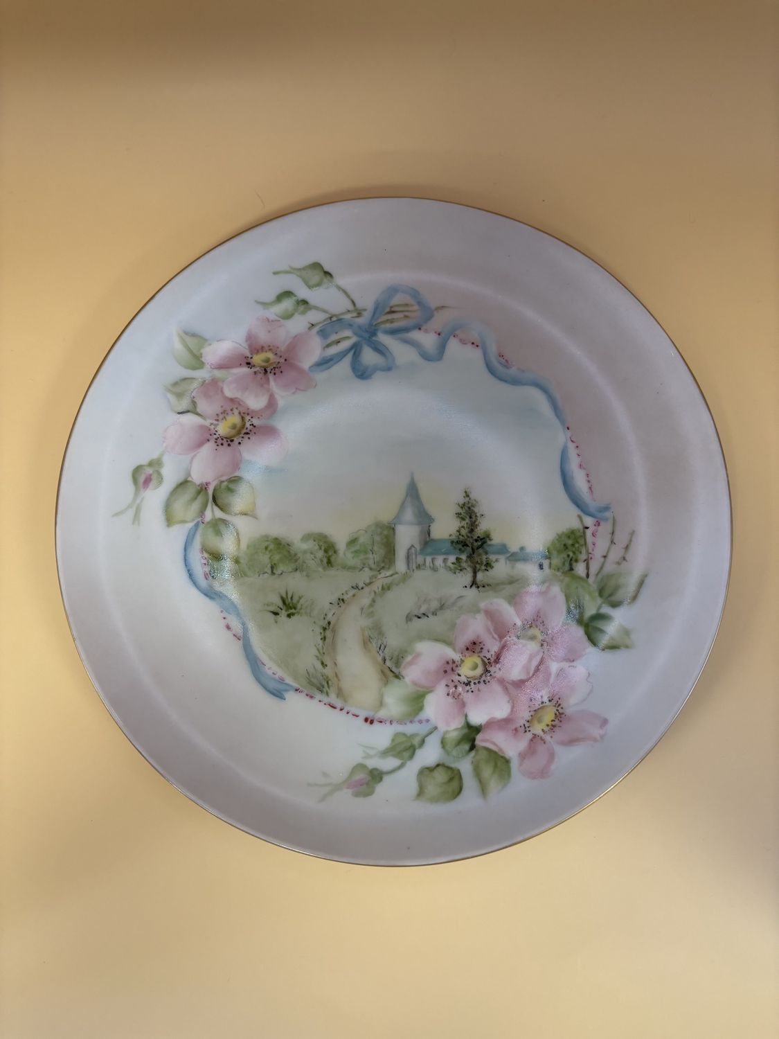 Porcelain. USA. Plate. Hand Painted. Scene of Building and Landscape. Flower Designs and Blue Ribbon Pattern.