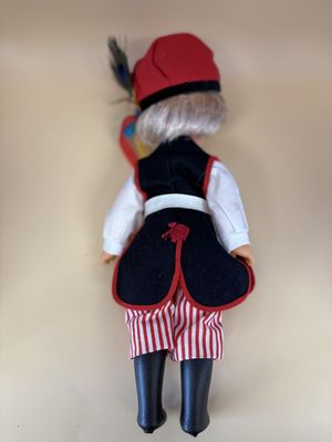 Doll. Polish Folk Girl. Blonde Hair. Vest. Red and White Striped Pants and Black Boots.