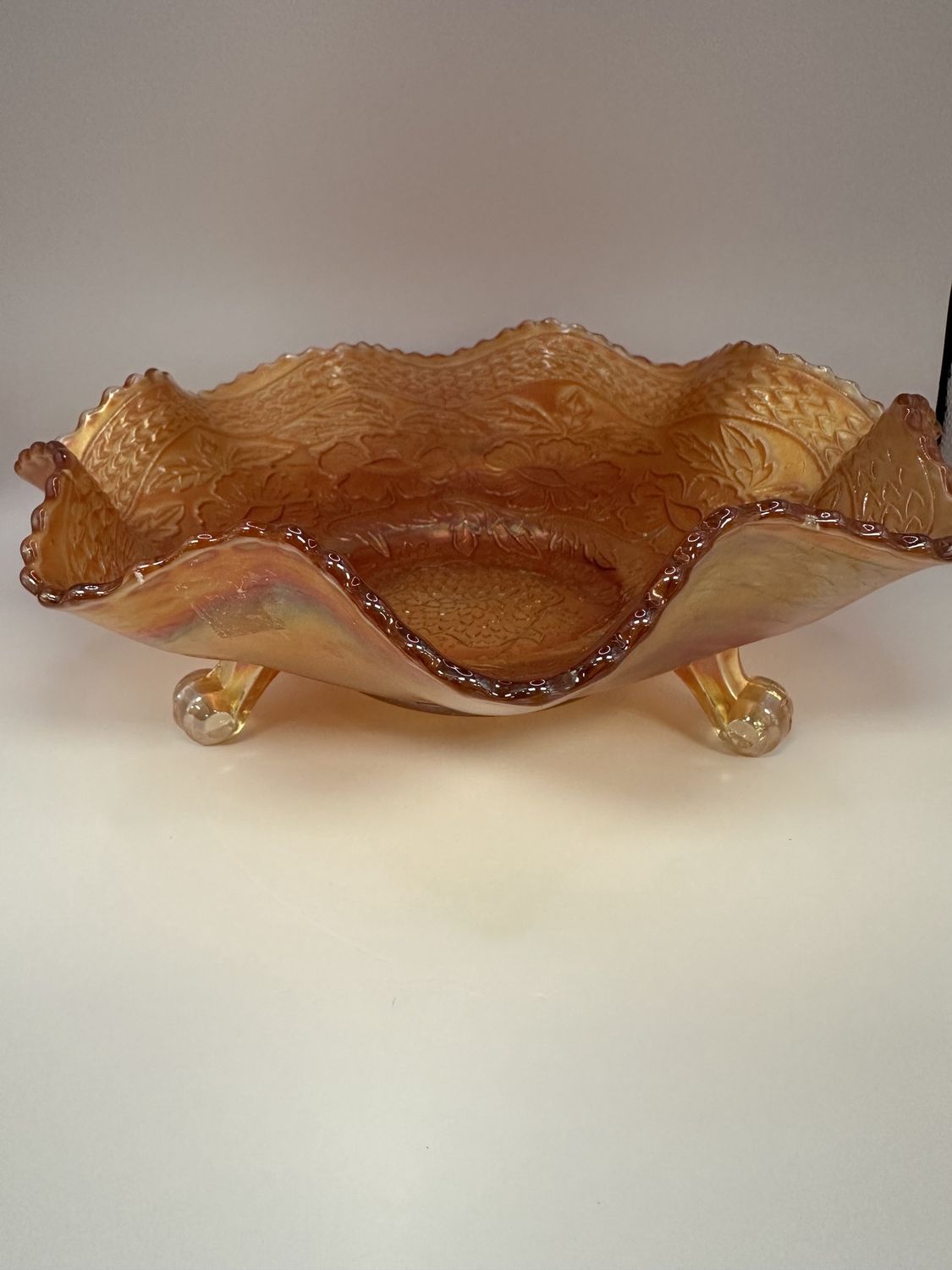 Glass. USA. Fenton. Carnival Glass. Footed Bowl with Floral Pattern and Ruffled Edge. Marigold. 9.75&quot;W