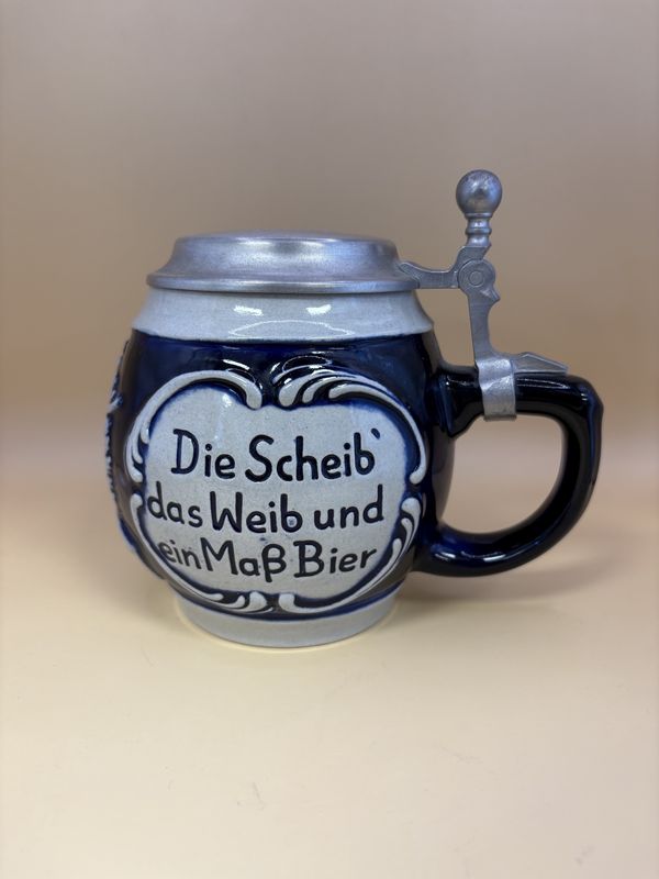Stein. West Germany. Stein with Engraved Lid. Translation of sides: &quot;The target, the woman, and a pint of beer are the marksman&#39;s greatest pleasure&quot;. Blue &amp; Gray. 1992. 5.75&quot;H