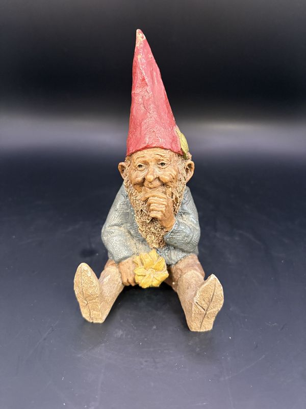 Sculpted Figure. USA. Tom Clark. Mugmon. Gnome Sitting w/Legs Out, Holding a Yellow Flower in One Hand &amp; Chin in Other. 1984. 5&quot;H
