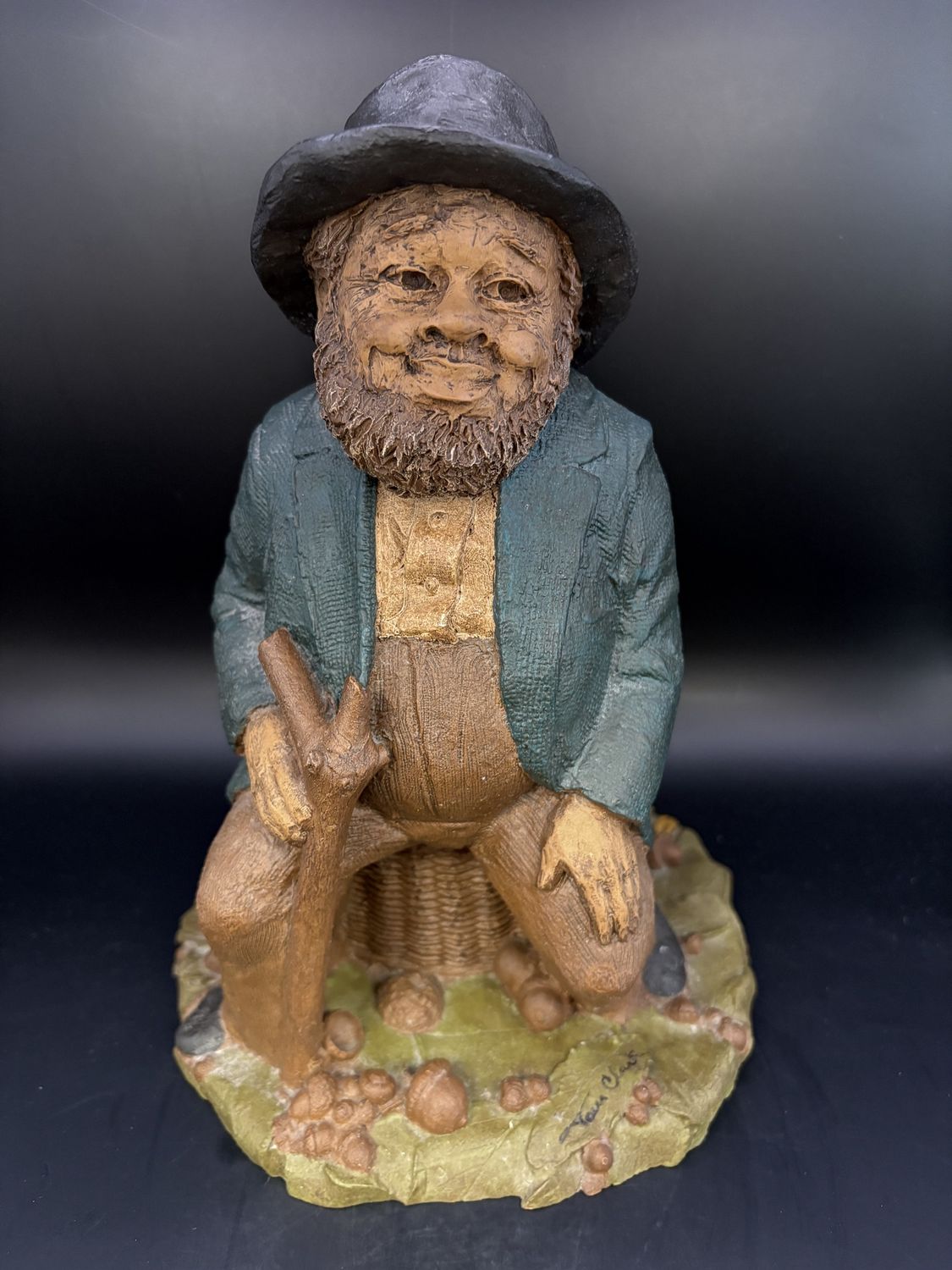 Sculpted Figure. USA. Tom Clark. Signed. Lawrence. Man of Color Seated on a Basket Amid Peanut Hulls, Corn, &amp; Black-eyed Peas. 1981. 8.5&quot;H