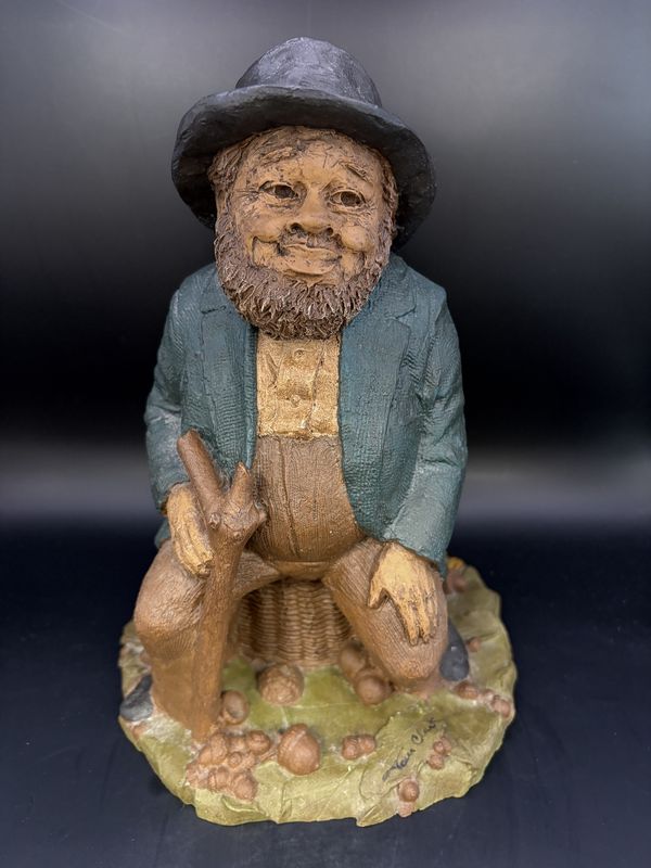 Sculpted Figure. USA. Tom Clark. Signed. Lawrence. Man of Color Seated on a Basket Amid Peanut Hulls, Corn, &amp; Black-eyed Peas. 1981. 8.5&quot;H