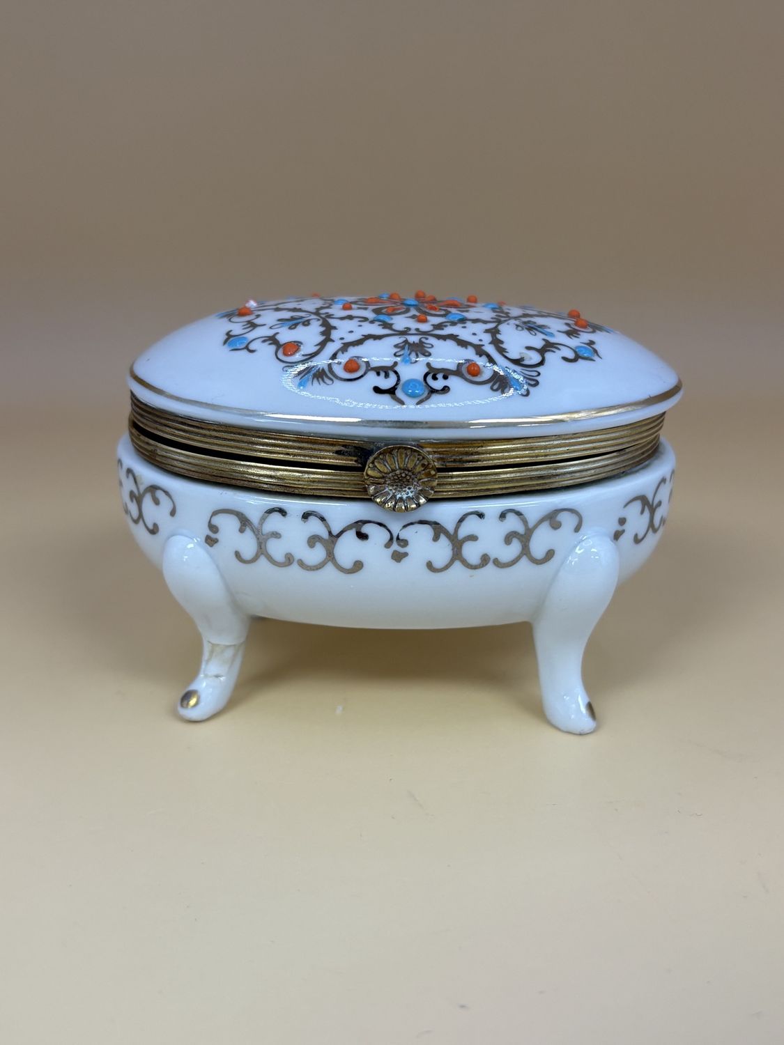 Porcelain. Germany. Kalk. 4-Legged Oval Trinket Box w/Brass Trim. White with Blue &amp; Orange Detailing (1955-1960). 3.5&quot;W