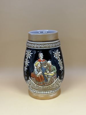 Stein. Brazil. Ceramarte. Two Men and a Woman, w/Edelweiss  &amp; Houses. Tan &amp; Blue. 6"H