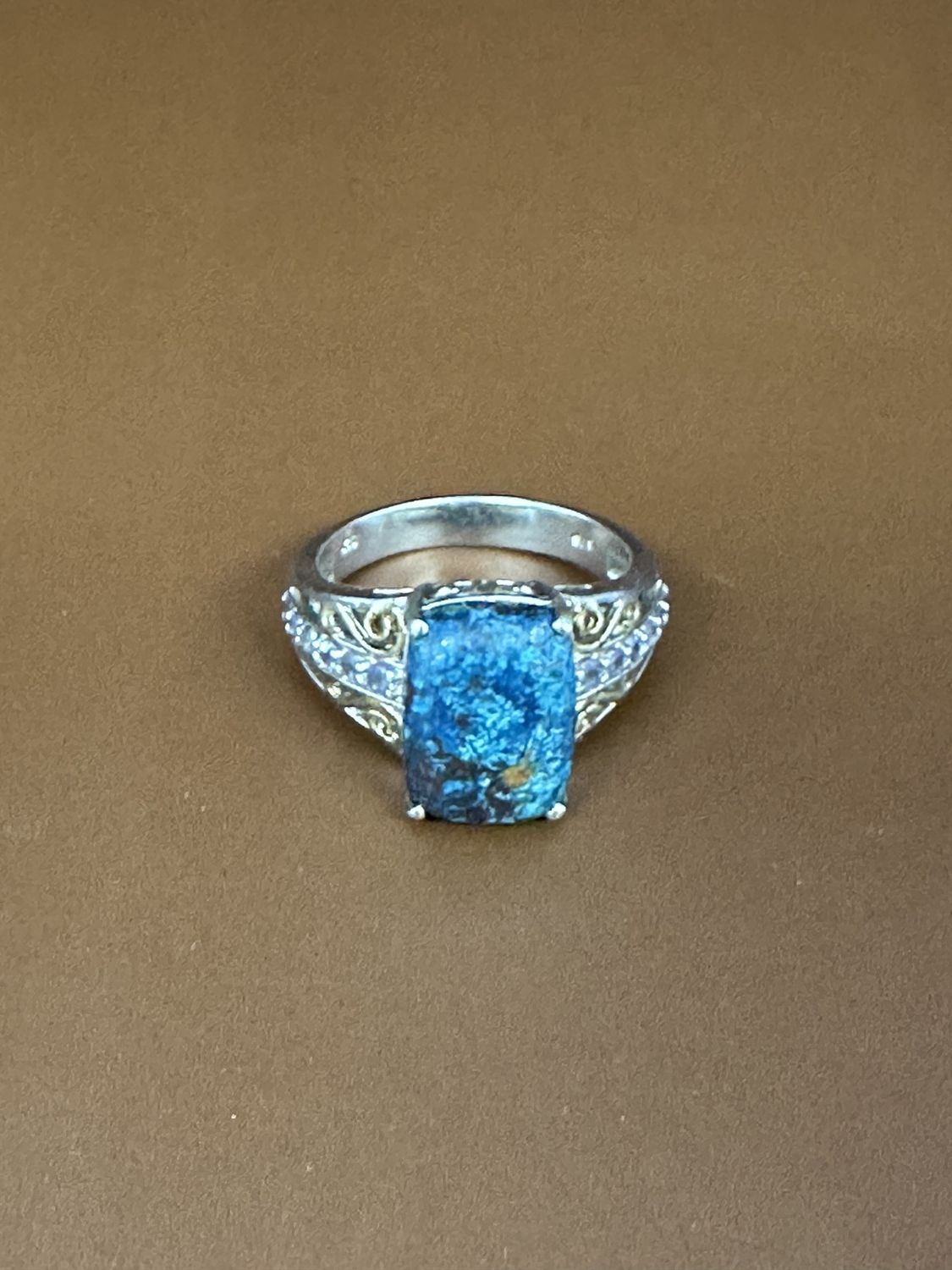 Jewelry. Ring. Sterling Silver Band w/Cushion Cut Chrysocolla Stone, Flanked by 12 Petite Tanzanites in a Filigree Setting. Size 9.5