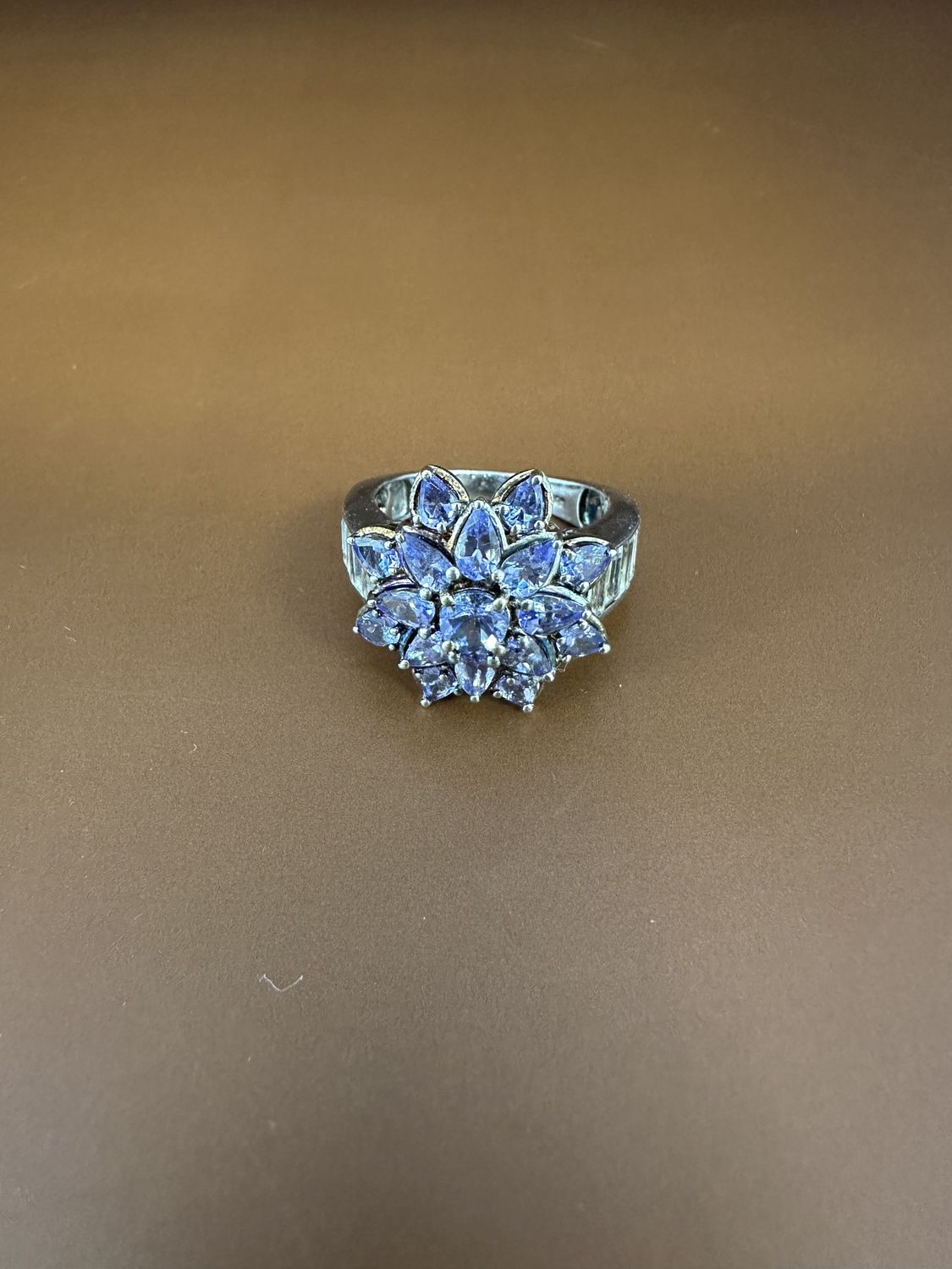 Jewelry. Ring. Sterling Silver Band w/3 Carats of Tanzanite Flower, w/Side Baguettes (White Topaz?). Size 10