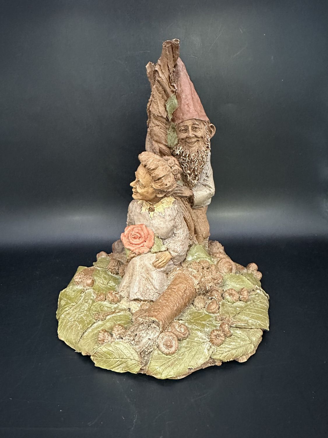 Sculpted Figure. USA. Tom Clark. Sugar &amp; Spice. Woman Sitting Against Tree, w/Rose in Lap &amp; Gnome Behind Her (green leaves). 1984. 6.5&quot;H