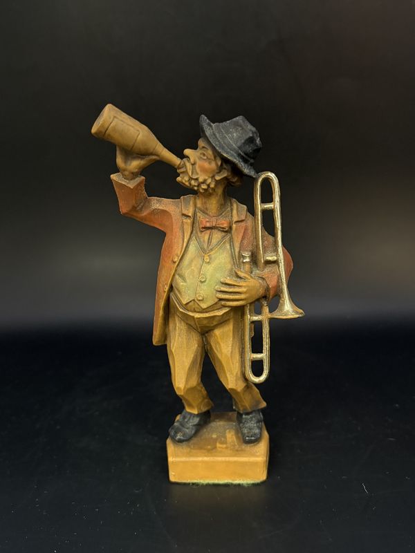 Figurine. Wood. Anri. Italy. Man Drinking from Bottle and Holding Trombone. 5.5&quot;H