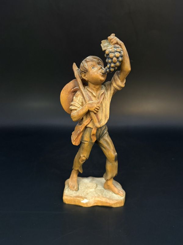 Figurine. Wood. Anri. Italy. Boy with Hat and Sticks and Eating Grapes. 5.5&quot;H