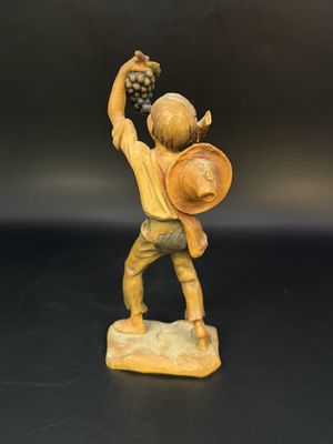 Figurine. Wood. Anri. Italy. Boy with Hat and Sticks and Eating Grapes. 5.5"H