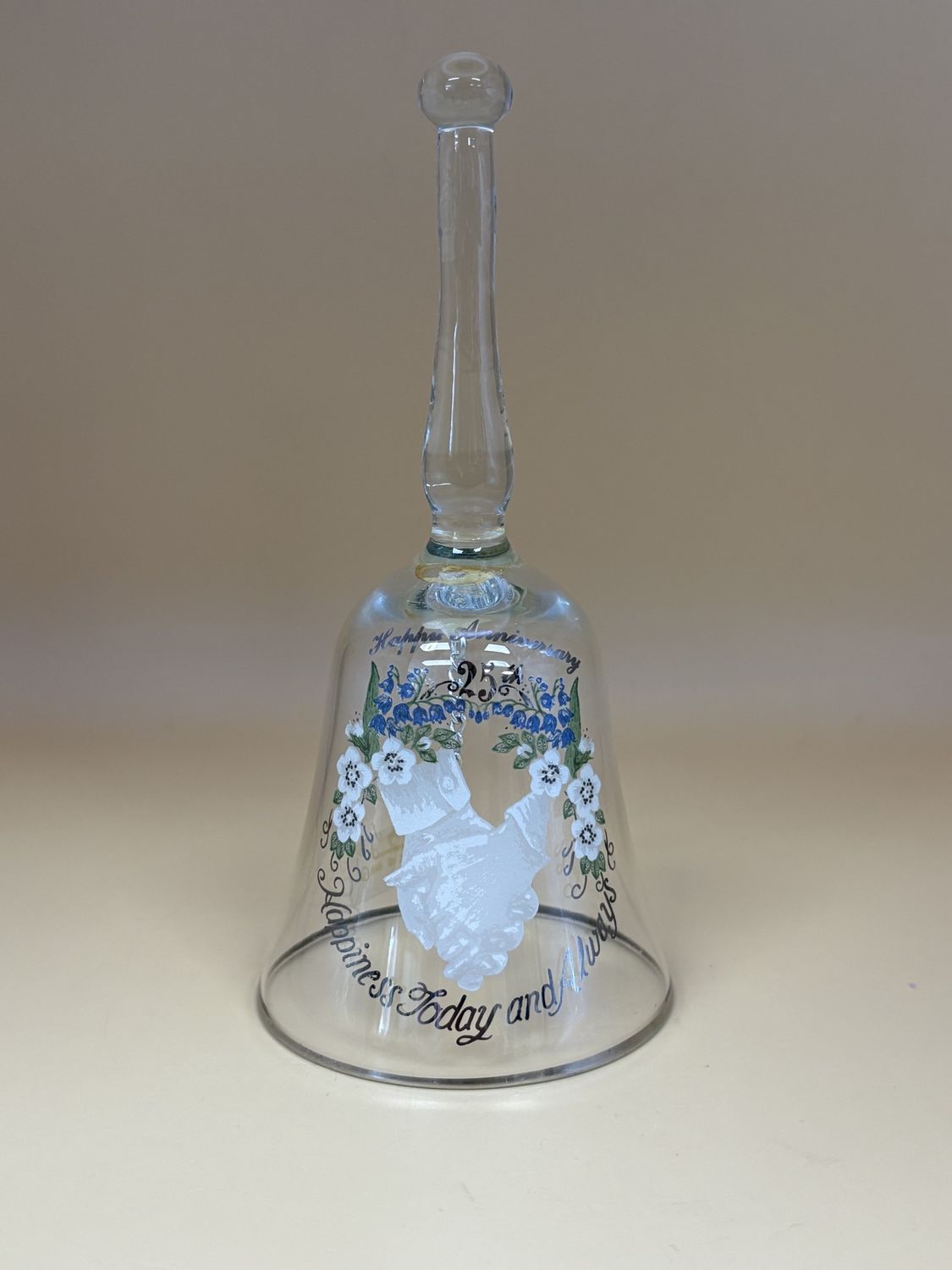 Glass. USA. Viking USA. 25th Anniversary Bell. Art of Hands Holding w/ White and Blue Floral Accents. &quot;Happiness Today and Always&quot; at Bottom.