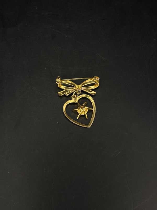 Jewelry. Pin. Gold Heart and Ribbon w/ Pink Rhinestone Hanging in Center. 1.25"h