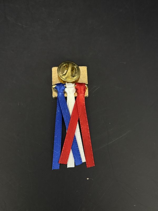 Jewelry. Pin. "God Bless America" Gold Tone Pin w/ Flag Engraved. Red White Blue Ribbons Attached. 2"H