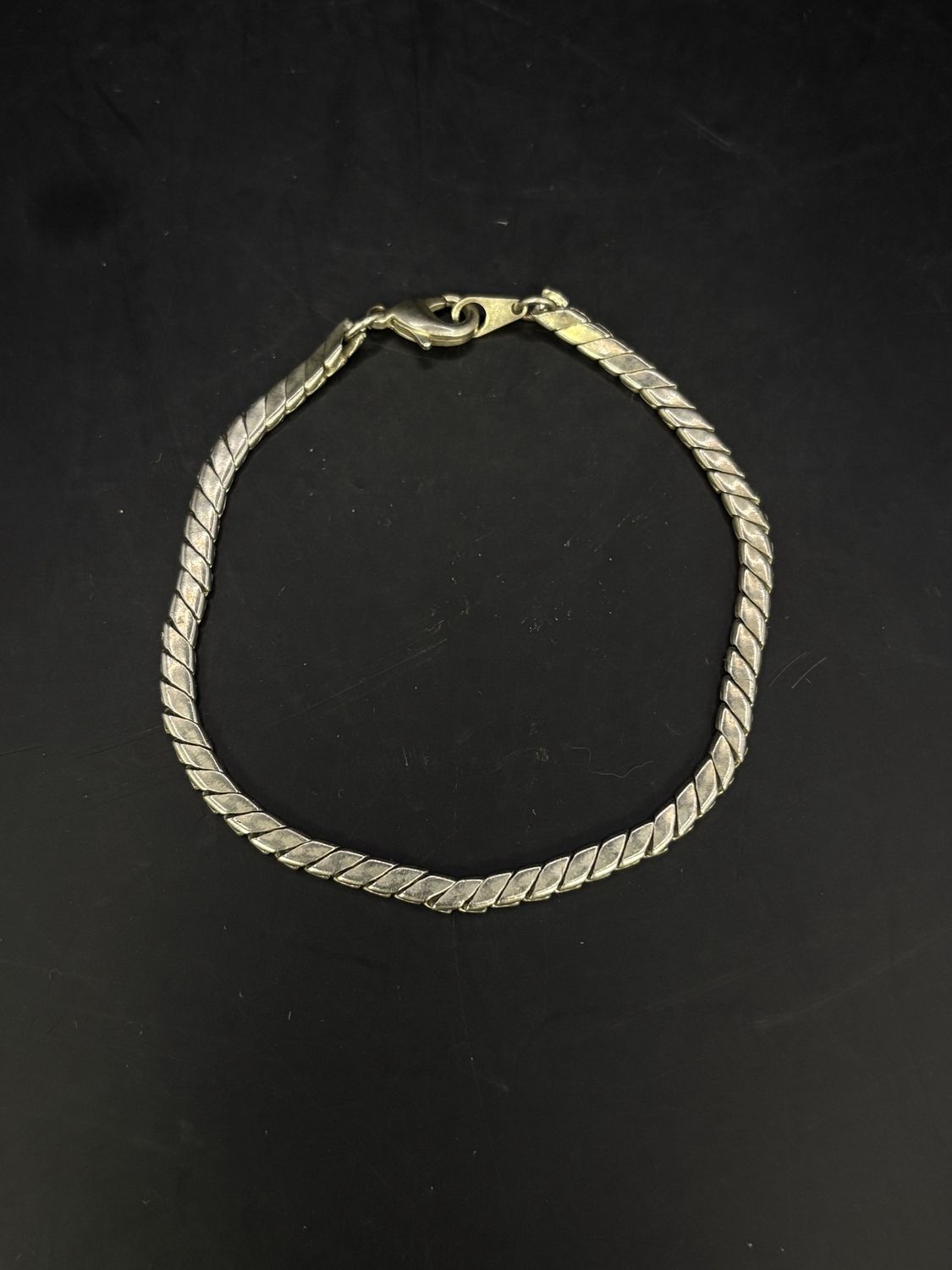 Jewelry. Bracelet. Silver Toned Twisted Shape Charm.  3.5&quot;L