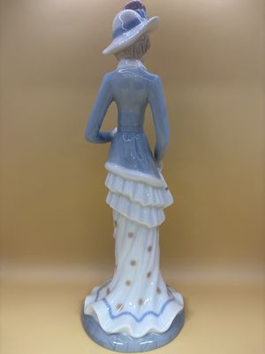 Figurine. Spain. Lladro. Woman Wearing Blue. Flower Hat and White Purse.