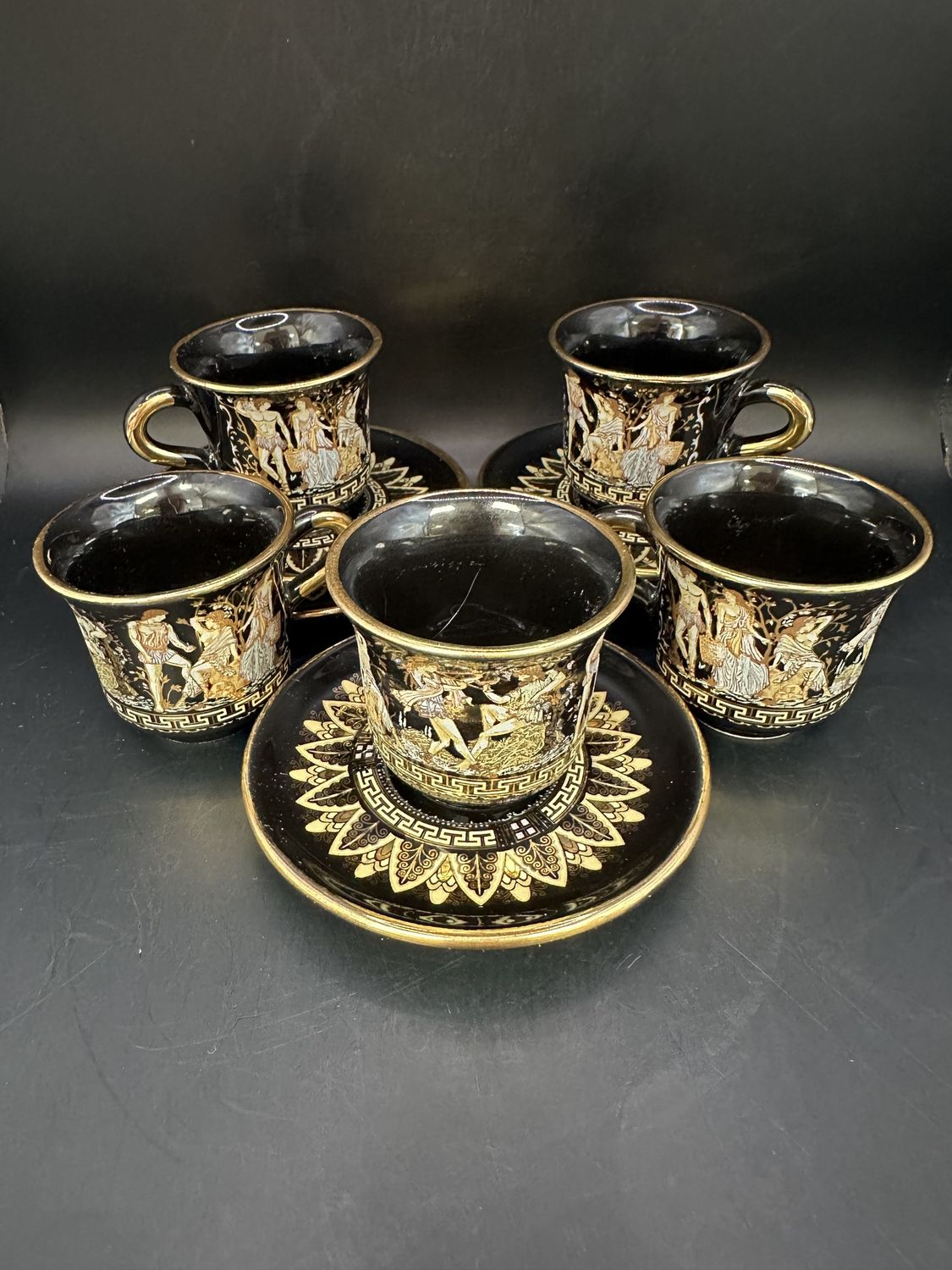 Porcelain. Greece. Spyropoulos. Greek Key Demitasse Cup &amp; Saucer w/Images of Ancient Greek Men &amp; Women. Black with 24 Karat Gold Trim (Set of 5). Circa 1970s. 2.5&quot;H