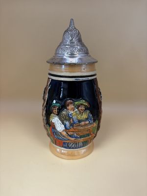 Stein. West Germany. Two Women and a Man at a Table w/ Flowers on Sides and Text "Daslieber wir" "Froh bein Bier." 7.5"H