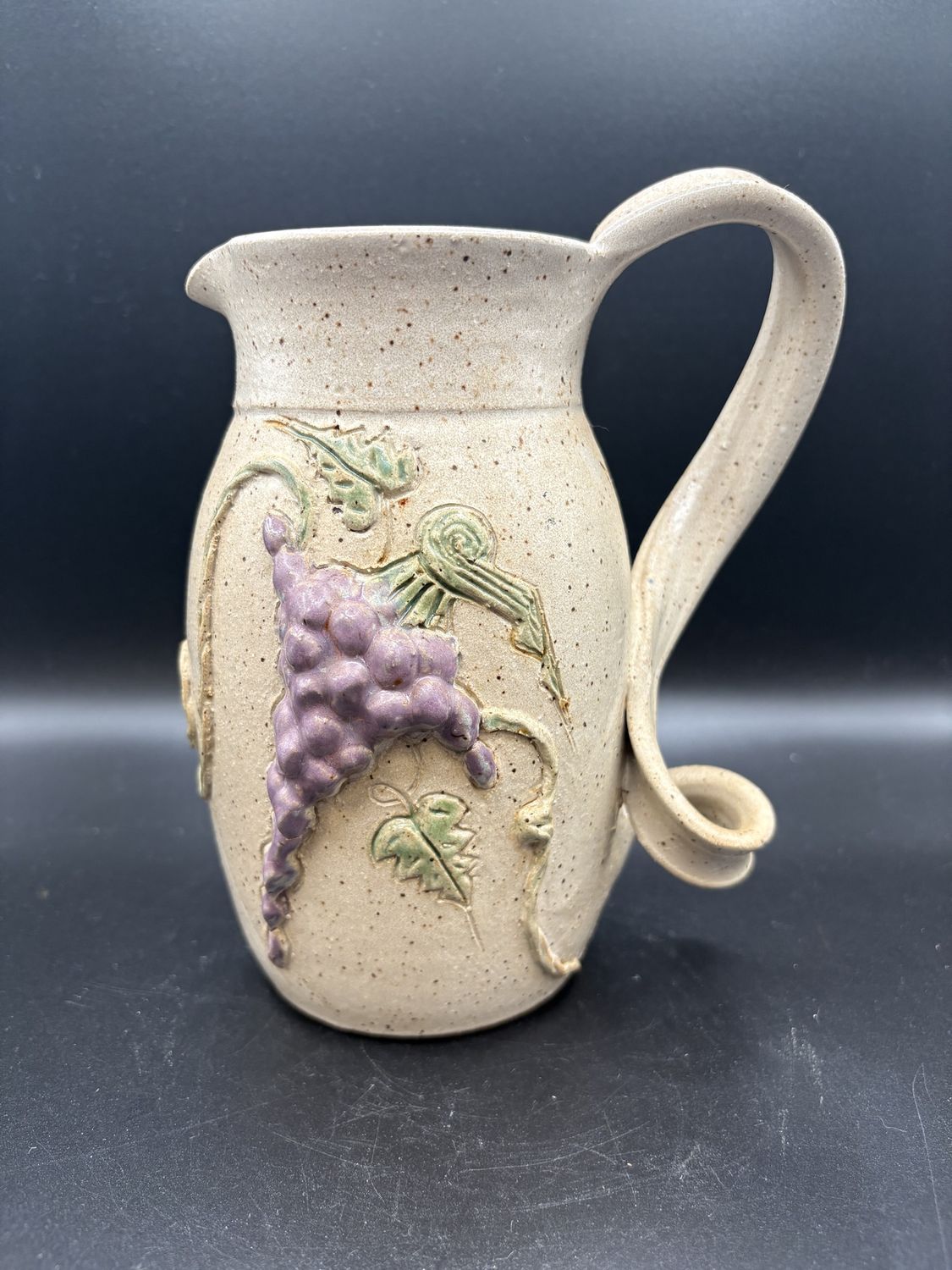 Ceramic. Handmade Speckled Pitcher w/ Grape Vine Design on Sides and Twisted Handle. 8&quot;H
