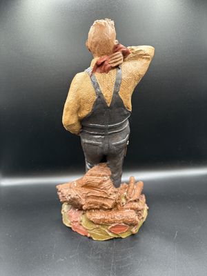 Sculpted Figure. USA. Tom Clark. #1109 "Marion the Farmer." Man Leaning Back w/ Logs at Feet. 1985. Signed. 12"H