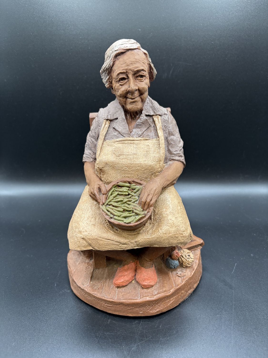 Sculpted Figurine. USA. Tom Clark. &quot;Nellie.&quot; Older Woman Sitting w/ Bowl of Green Beans. 1981. Signed. 9&quot;H